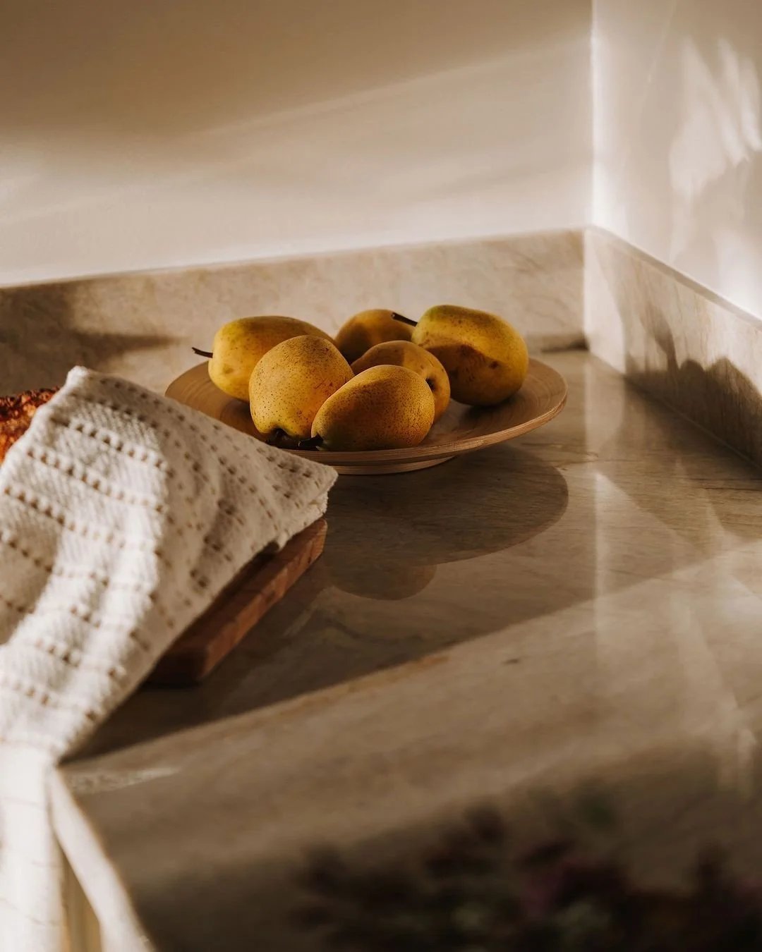 Fresh fruit arranged on a pale surface.