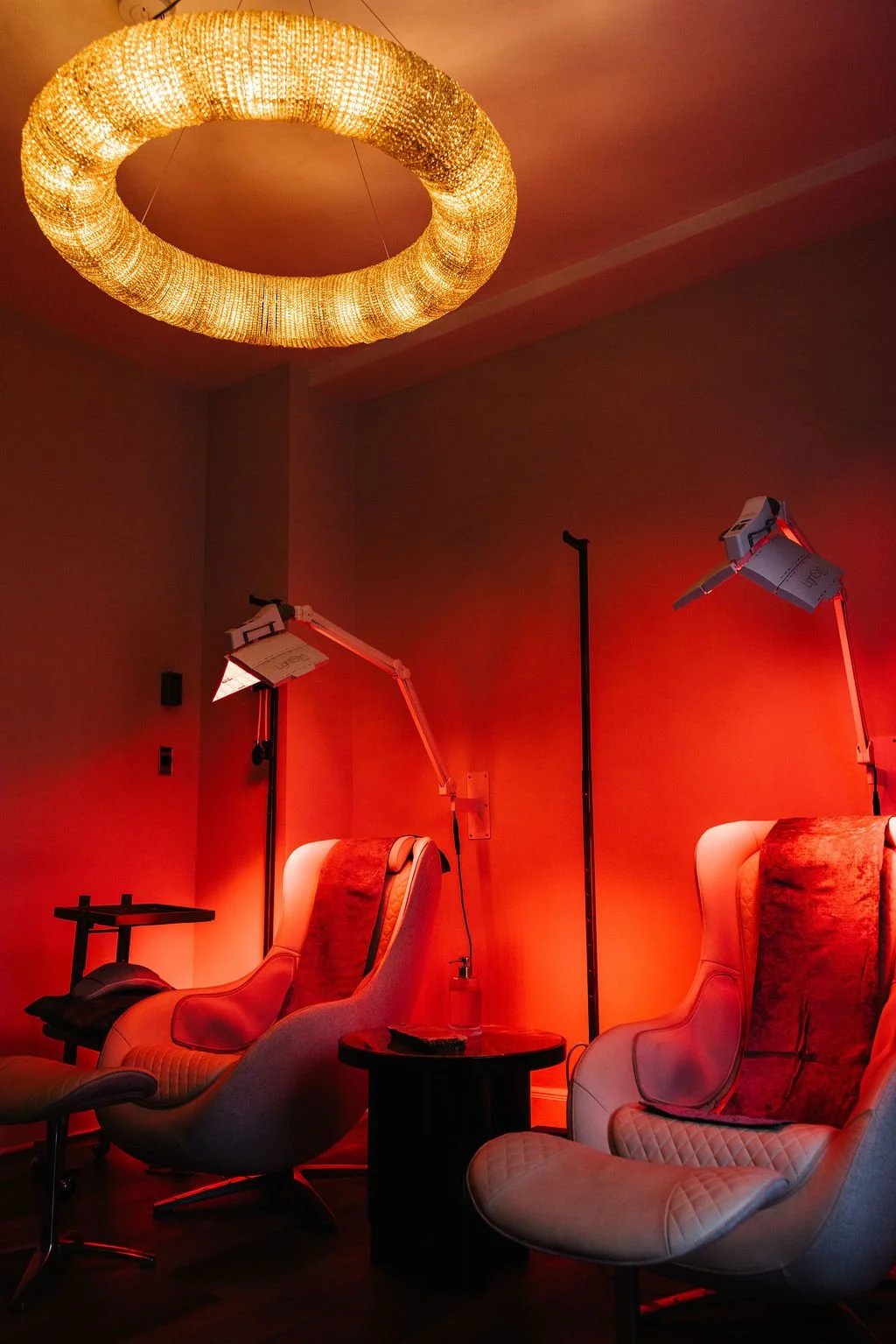 A Medworks treatment room set up for red-light therapy, with two reclining chairs.