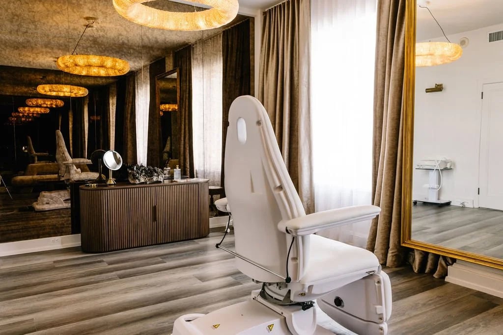 A treatment suite at the Medworks studio, with warm wood floors and soft lighting.