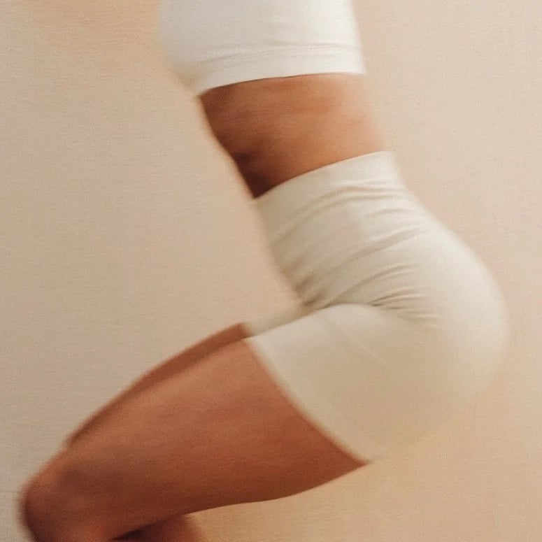 A member in cream activewear caught mid-movement.